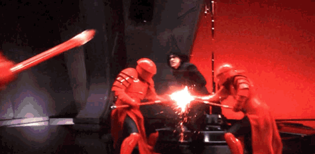 a group of red soldiers are fighting a man in a black suit