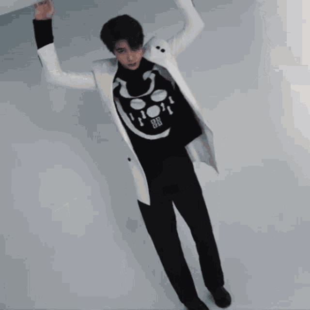 a man wearing a black sweater with a smiley face and the number 88 on it
