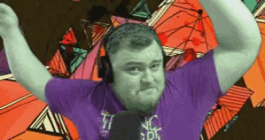 a man wearing headphones and a purple shirt that says ' nc ' on it