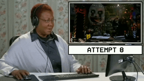 a woman wearing headphones is playing attempt 8 on a computer screen