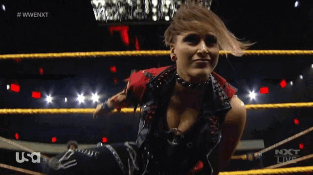 a woman in a wrestling ring with a usa logo on the bottom