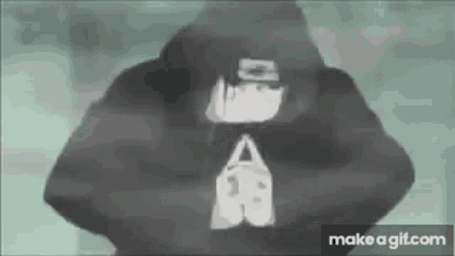 a person wearing a black hoodie with a white logo on the back .
