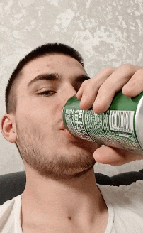 a man is drinking from a green can with a label that says ' sprite ' on it
