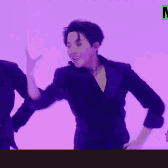 a man in a purple jacket is dancing on a purple background .