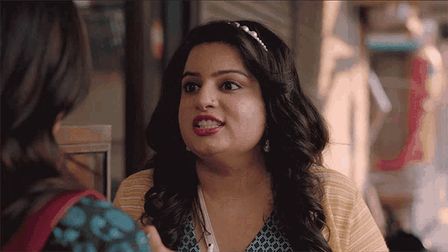 a woman with a nose ring talks to a friend