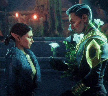 a man and a woman are standing next to each other and the man is holding a flower in his hand
