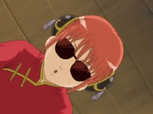 a red haired anime girl wearing sunglasses and headphones is laying down .