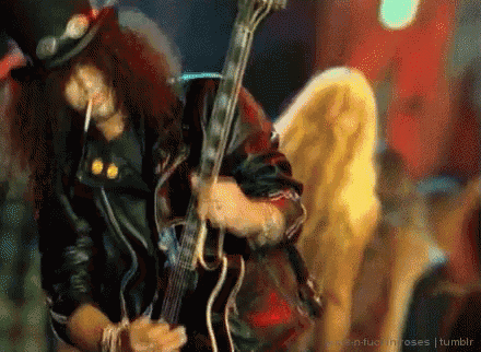 a man with wings is smoking a cigarette and playing a guitar