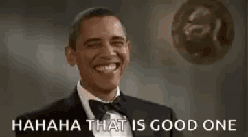 barack obama is laughing while wearing a tuxedo and bow tie and a ball is flying in the background .