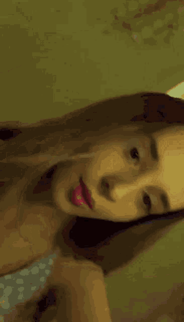 a close up of a woman 's face with a blurred background