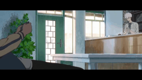 a man is standing in front of a counter in a room with a green door