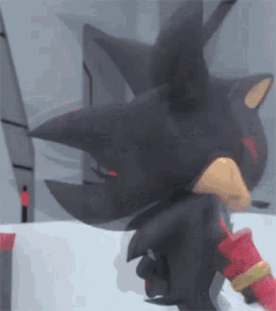 shadow the hedgehog from sonic the hedgehog is standing in front of a wall