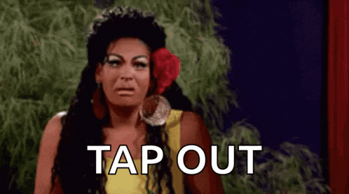 a woman with a flower in her hair is making a funny face and saying tap out .