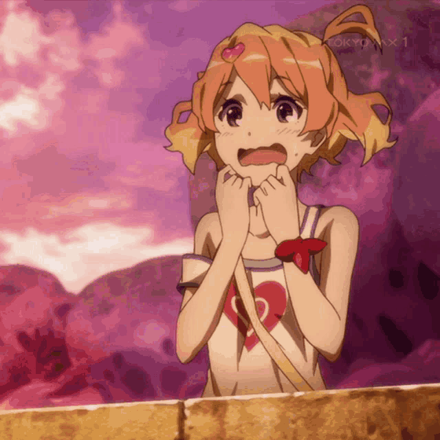 a girl with a heart on her shirt is standing in front of a tokyo mx 1 sign