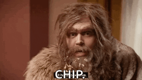 a man with a beard and long hair is wearing a fur coat and says `` chip '' .