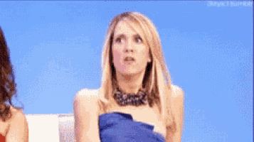 a woman in a blue dress is sitting in a chair
