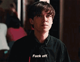 a young man in a black shirt is saying fuck off