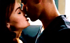 a man and a woman are kissing each other on the nose .
