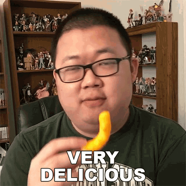 a man wearing glasses is eating a very delicious item
