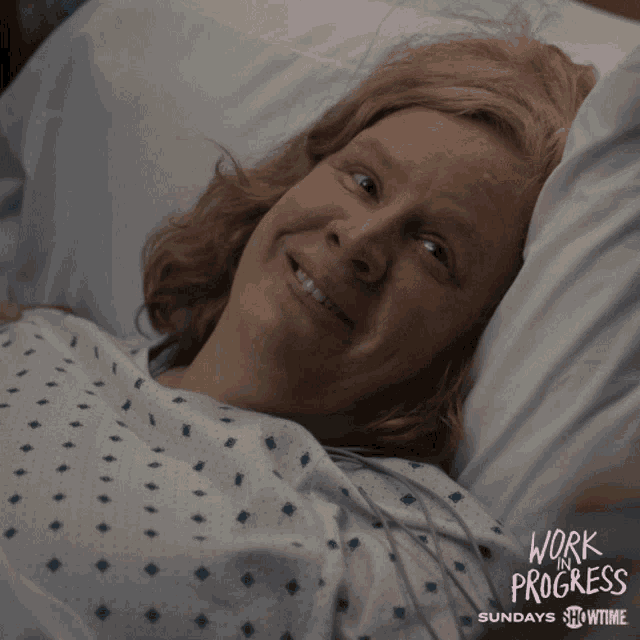 a woman is laying in a hospital bed with the word cow on her shirt