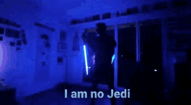 a person is holding a laser pointer in a dark room and saying i am no jedi .