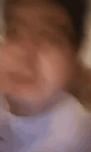 a blurry photo of a person 's face with a blurred background