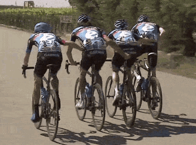 a group of bicycle riders wearing garmin jerseys
