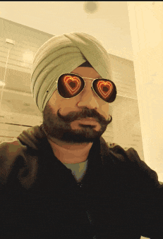 a man in a turban and heart shaped sunglasses
