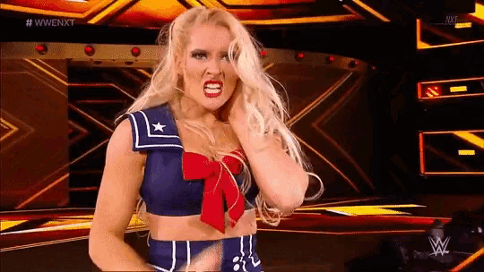a woman is standing on a stage wearing a sailor costume .