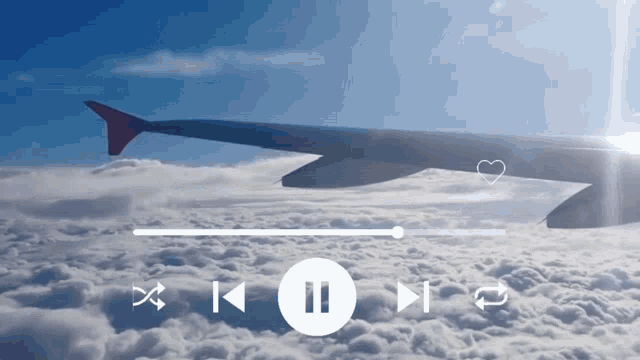 an airplane is flying through the clouds with a pause button in the middle of the screen