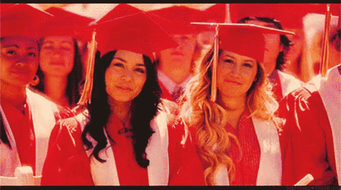 a group of graduates wearing red caps and gowns pose for a photo