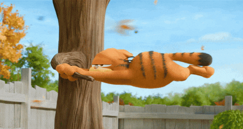 garfield is laying on a tree trunk with a squirrel in his mouth