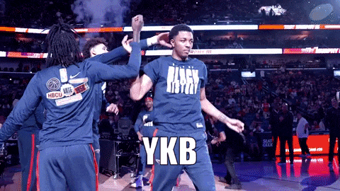 a basketball player wearing a shirt that says ykb is dancing on the court