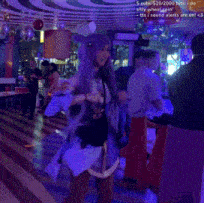 a woman in a purple wig is dancing in a room with a purple background