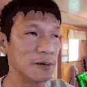 a close up of a man 's face with a green object behind him .