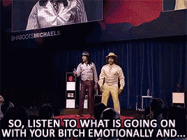 two men are standing on a stage in front of a crowd with the words so listen to what is going on with your bitch emotionally and