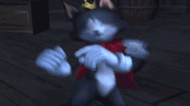 a cat with a crown on its head and a red bow around its neck