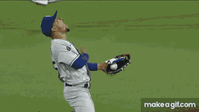 a baseball player wearing a la hat kneeling down