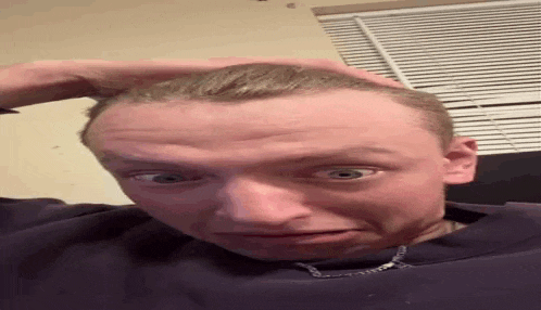 a man with his hand on his head is making a funny face