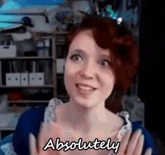 a woman with red hair is making a funny face and saying `` absolutely '' .