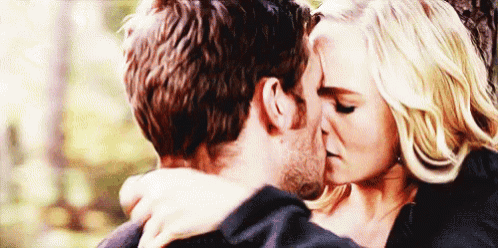 a man and a woman are kissing and hugging each other .