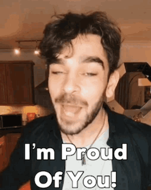 a man with a beard is singing a song and saying `` i 'm proud of you '' .