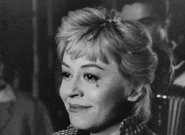 a black and white photo of a woman with tears in her eyes