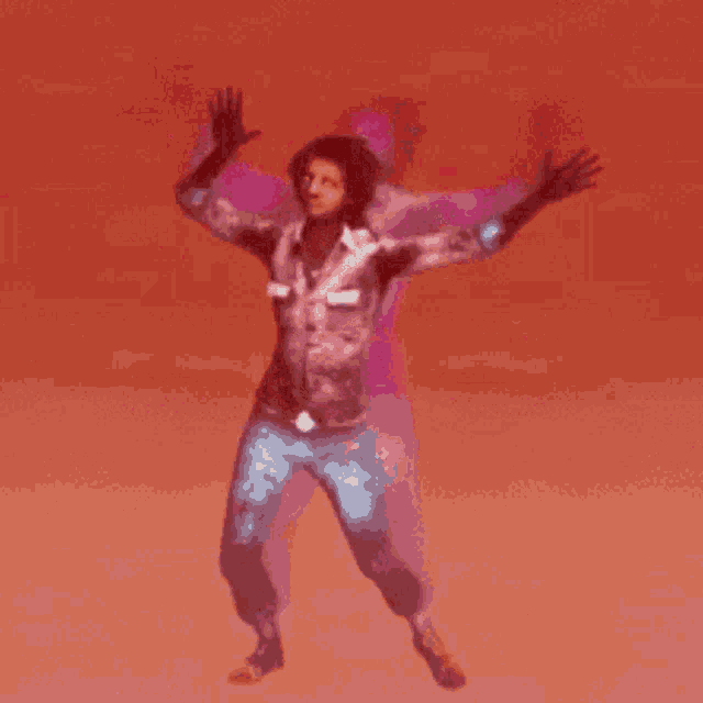 a man is dancing with his arms outstretched against a red background