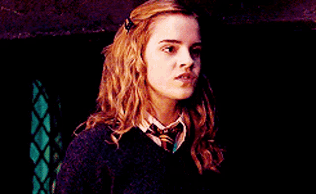 a close up of a girl wearing a tie and sweater