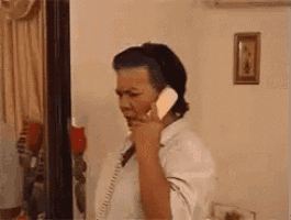 a woman is talking on a phone in a living room .