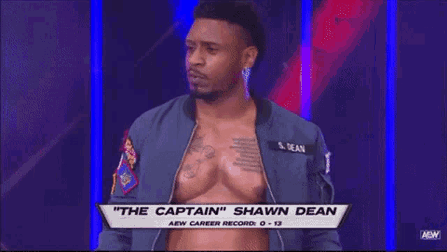 a man in a blue jacket with the name shawn dean on his chest