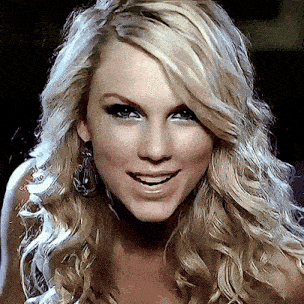a close up of a woman 's face with blonde hair and earrings