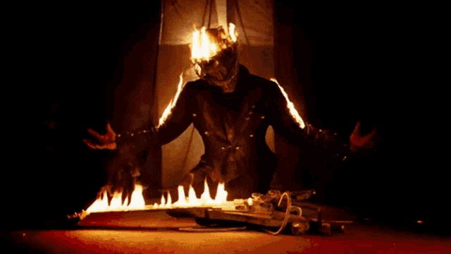 a man with a helmet on is surrounded by fire