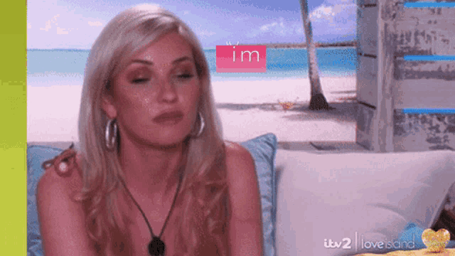 a woman sits on a couch in front of a screen that says i 'm on it